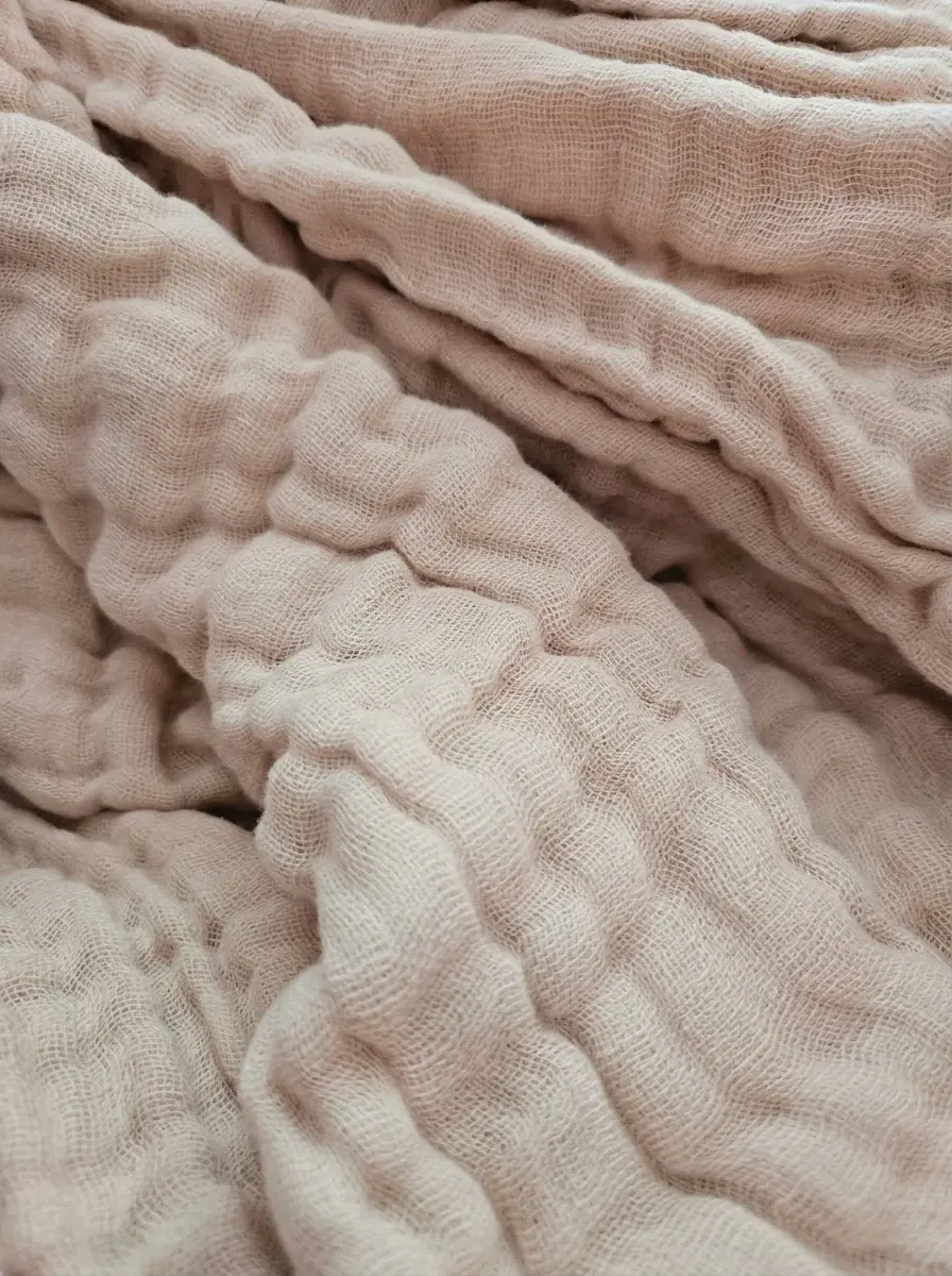 Soft blanket beside a large window